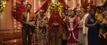 Movie still from “The Lunchbox” (2013), directed by Ritesh Batra – A group of people standing in front of a stage; Wide shot, High angle