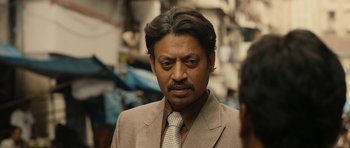 Movie still from “The Lunchbox” (2013), directed by Ritesh Batra – A person wearing a suit and a tie; Close Up shot, Over the shoulder angle