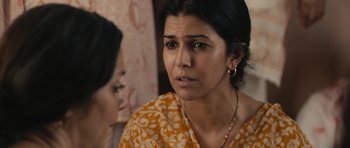 Movie still from “The Lunchbox” (2013), directed by Ritesh Batra – A person wearing a yellow and white dress; Close Up shot, Over the shoulder angle