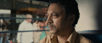 Movie still from “The Lunchbox” (2013), directed by Ritesh Batra – A person wearing a yellow shirt; Close Up shot, Over the shoulder angle