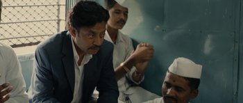 Movie still from “The Lunchbox” (2013), directed by Ritesh Batra – A group of men sitting next to each other on top of a train; Close Up shot, High angle