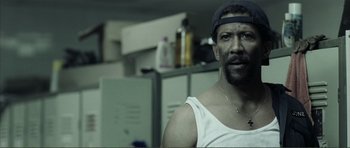 Movie still from “The Machinist” (2004), directed by Brad Anderson – A person wearing a hat; Close Up shot, Over the shoulder angle