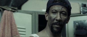 Movie still from “The Machinist” (2004), directed by Brad Anderson – A person wearing a hat; Close Up shot, High angle