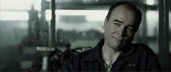 Movie still from “The Machinist” (2004), directed by Brad Anderson – A person wearing a jacket; Close Up shot, Over the shoulder angle