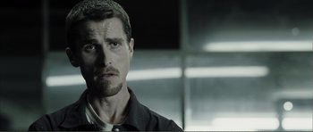 Movie still from “The Machinist” (2004), directed by Brad Anderson – A person wearing a shirt and tie; Close Up shot, Over the shoulder angle