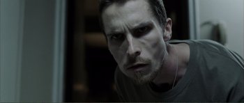 Movie still from “The Machinist” (2004), directed by Brad Anderson – A person with a beard; Close Up shot, Low angle