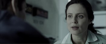 Movie still from “The Machinist” (2004), directed by Brad Anderson – A person wearing a white shirt; Close Up shot, Over the shoulder angle
