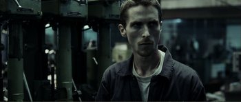 Movie still from “The Machinist” (2004), directed by Brad Anderson – A person wearing a jacket; Close Up shot, High angle