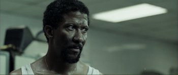 Movie still from “The Machinist” (2004), directed by Brad Anderson – A person wearing a white shirt; Close Up shot, Low angle