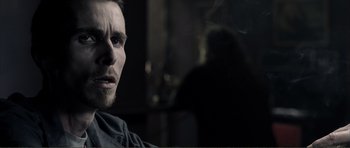 Movie still from “The Machinist” (2004), directed by Brad Anderson – A person with a beard; Close Up shot, Over the shoulder angle