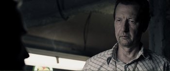 Movie still from “The Machinist” (2004), directed by Brad Anderson – A person wearing a plaid shirt; Close Up shot, Low angle