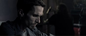 Movie still from “The Machinist” (2004), directed by Brad Anderson – A person with a beard looking down; Close Up shot, Low angle