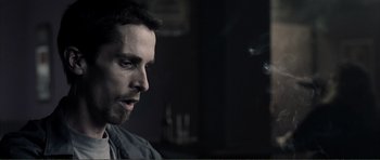 Movie still from “The Machinist” (2004), directed by Brad Anderson – A person with a beard; Close Up shot, Over the shoulder angle