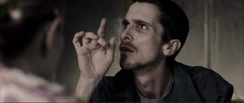Movie still from “The Machinist” (2004), directed by Brad Anderson – A person smoking a cigarette; Close Up shot, Low angle