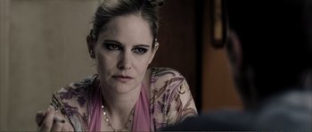 Movie still from “The Machinist” (2004), directed by Brad Anderson – A person wearing a pink shirt; Close Up shot, Over the shoulder angle