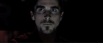 Movie still from “The Machinist” (2004), directed by Brad Anderson – A person looking at the camera; Close Up shot, Low angle