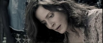 Movie still from “The Machinist” (2004), directed by Brad Anderson – A person with long black hair; Close Up shot, Low angle