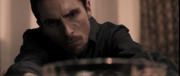 Movie still from “The Machinist” (2004), directed by Brad Anderson – A person wearing a black shirt; Close Up shot, Low angle