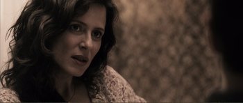 Movie still from “The Machinist” (2004), directed by Brad Anderson – A person wearing a jacket; Close Up shot, Over the shoulder angle