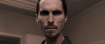 Movie still from “The Machinist” (2004), directed by Brad Anderson – A person with a beard; Close Up shot, Low angle