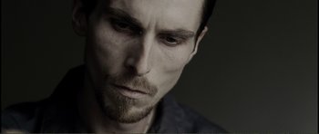Movie still from “The Machinist” (2004), directed by Brad Anderson – A person with a beard; Close Up shot, Low angle
