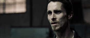 Movie still from “The Machinist” (2004), directed by Brad Anderson – A person with a beard; Close Up shot, Low angle