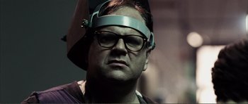 Movie still from “The Machinist” (2004), directed by Brad Anderson – A man with glasses and a helmet on his head; Close Up shot, Low angle