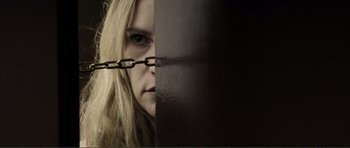 Movie still from “The Machinist” (2004), directed by Brad Anderson – A woman with a chain around her face; Extreme Close Up shot, Low angle