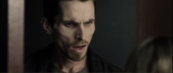 Movie still from “The Machinist” (2004), directed by Brad Anderson – A person wearing a black shirt; Close Up shot, Low angle