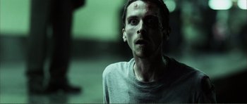 Movie still from “The Machinist” (2004), directed by Brad Anderson – A person with a face covered in blood; Close Up shot, Low angle