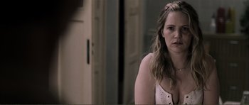 Movie still from “The Machinist” (2004), directed by Brad Anderson – A woman with long blonde hair is looking at the camera; Close Up shot, Over the shoulder angle