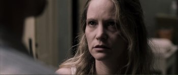 Movie still from “The Machinist” (2004), directed by Brad Anderson – A person with long blonde hair; Close Up shot, Over the shoulder angle