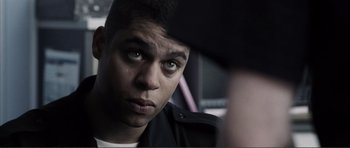 Movie still from “The Machinist” (2004), directed by Brad Anderson – A person looking at the camera; Close Up shot, Over the shoulder angle