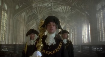 Movie still from “The Madness of King George” (1994), directed by Nicholas Hytner – A man in a black and white outfit holding a golden staff; Medium shot, Low angle
