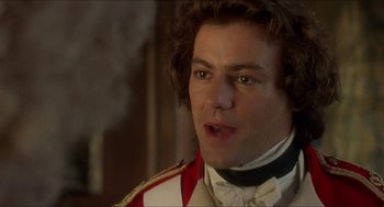 Movie still from “The Madness of King George” (1994), directed by Nicholas Hytner – A person wearing a suit and tie; Close Up shot, Over the shoulder angle