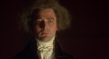 Movie still from “The Madness of King George” (1994), directed by Nicholas Hytner – A person wearing a suit and tie; Close Up shot, Low angle