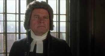 Movie still from “The Madness of King George” (1994), directed by Nicholas Hytner – An older man wearing a wig and a judge's wig; Close Up shot, Over the shoulder angle