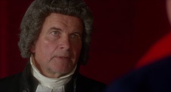 Movie still from “The Madness of King George” (1994), directed by Nicholas Hytner – An older man wearing a wig looking at the camera; Close Up shot, Over the shoulder angle