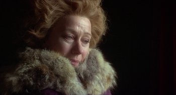 Movie still from “The Madness of King George” (1994), directed by Nicholas Hytner – An older woman wearing a fur coat and a purple jacket; Close Up shot, Over the shoulder angle