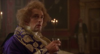 Movie still from “The Madness of King George” (1994), directed by Nicholas Hytner – A man in a suit holding a glass of wine; Medium shot, Low angle
