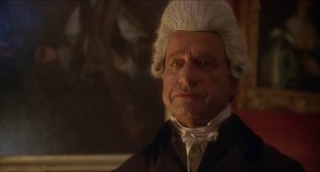 Movie still from “The Madness of King George” (1994), directed by Nicholas Hytner – An old man in a wig and a suit; Close Up shot, Over the shoulder angle