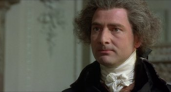 Movie still from “The Madness of King George” (1994), directed by Nicholas Hytner – A person wearing a suit and tie; Close Up shot, Over the shoulder angle