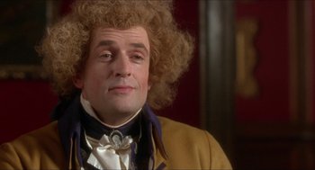 Movie still from “The Madness of King George” (1994), directed by Nicholas Hytner – A person wearing a suit and tie; Close Up shot, Over the shoulder angle