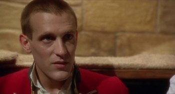 Movie still from “The Madness of King George” (1994), directed by Nicholas Hytner – A person wearing a red jacket; Close Up shot, Over the shoulder angle