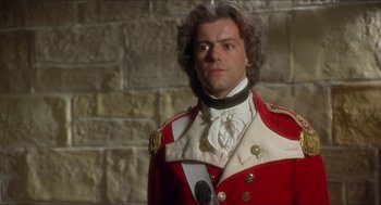Movie still from “The Madness of King George” (1994), directed by Nicholas Hytner – A man in a red and white uniform standing in front of a brick wall; Close Up shot, Over the shoulder angle