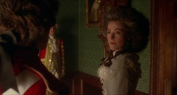 Movie still from “The Madness of King George” (1994), directed by Nicholas Hytner – A woman in a white dress standing next to a man in a red suit; Medium shot, Over the shoulder angle