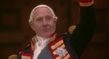 Movie still from “The Madness of King George” (1994), directed by Nicholas Hytner – An older man in a military uniform raising his hand; Close Up shot, Low angle