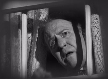 Movie still from “The Magnificent Ambersons” (1942), directed by Robert Wise – An old man looking out a window with a surprised look on his face; Close Up shot, Low angle