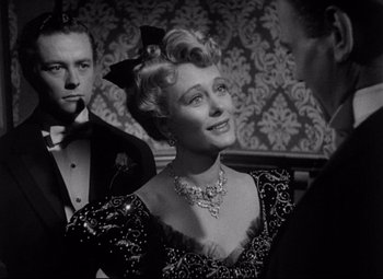 Movie still from “The Magnificent Ambersons” (1942), directed by Robert Wise – An old photo of a man and a woman; Medium shot, Over the shoulder angle