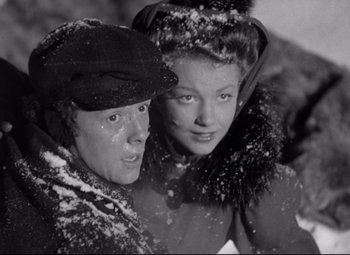 Movie still from “The Magnificent Ambersons” (1942), directed by Robert Wise – Two young women are posing for a picture in the snow; Close Up shot, Low angle
